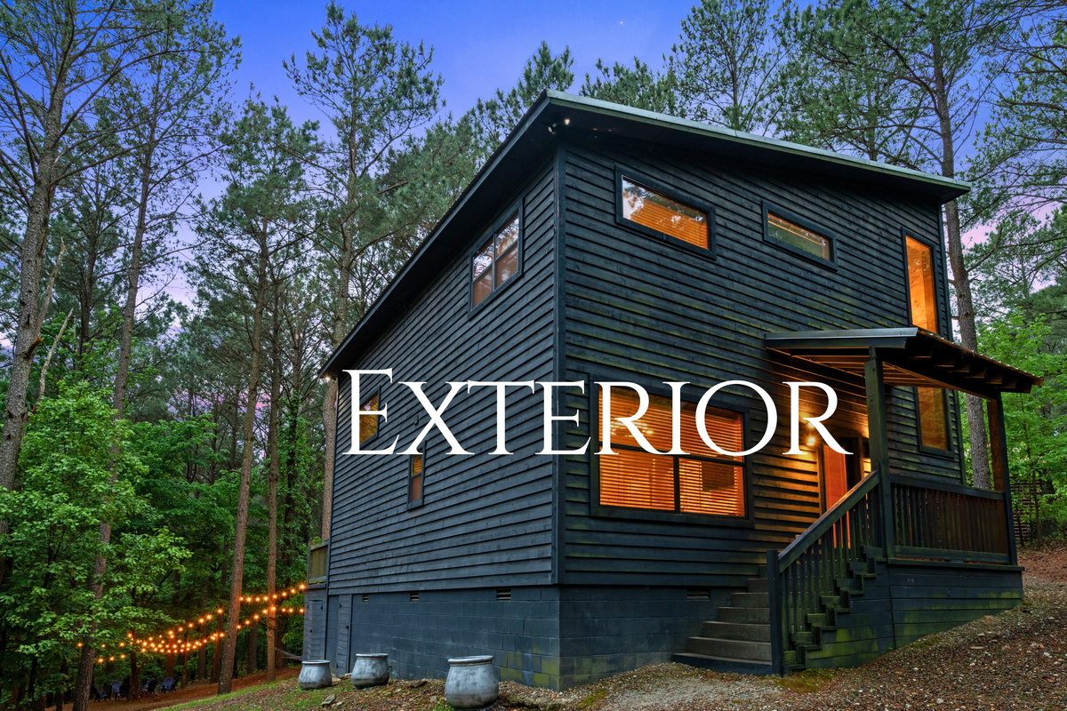 The cabin&rsquo;s exterior showcases a clean, modern rustic design that fits perfectly into the wooded surroundings.