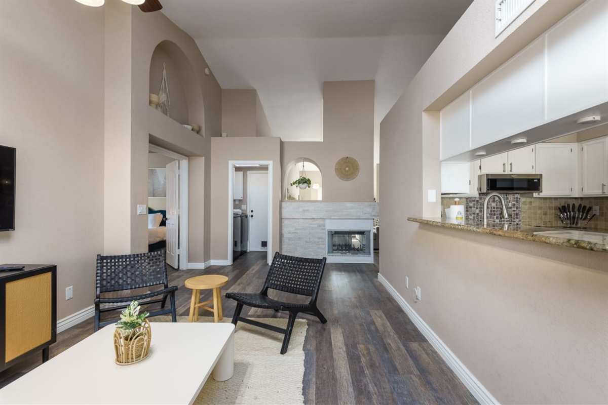 Living area with fireplace, TV, kitchen pass-through, and comfortable seating for relaxed indoor downtime.