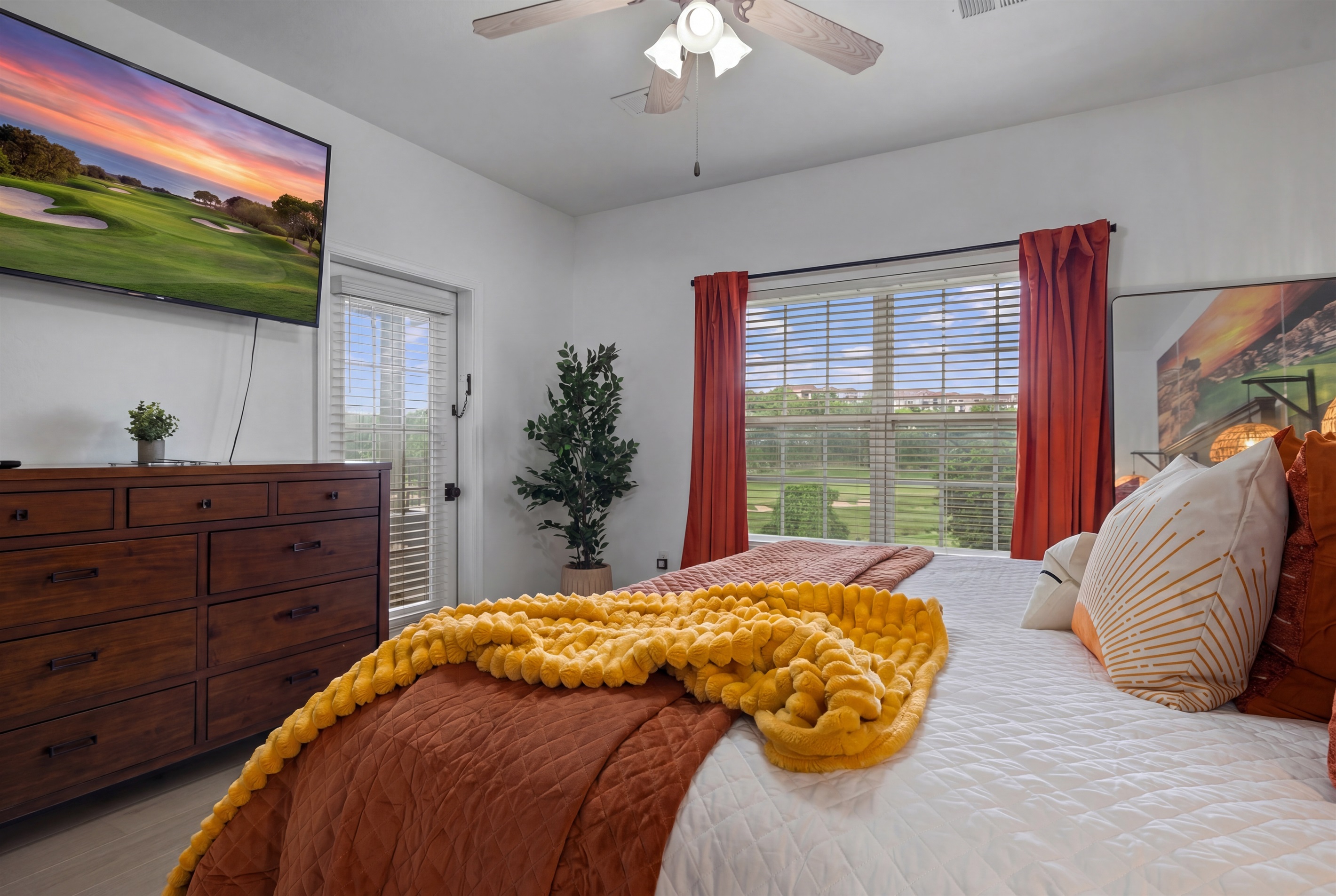 The primary bedroom has direct access to the deck and a beautiful view of the golf course