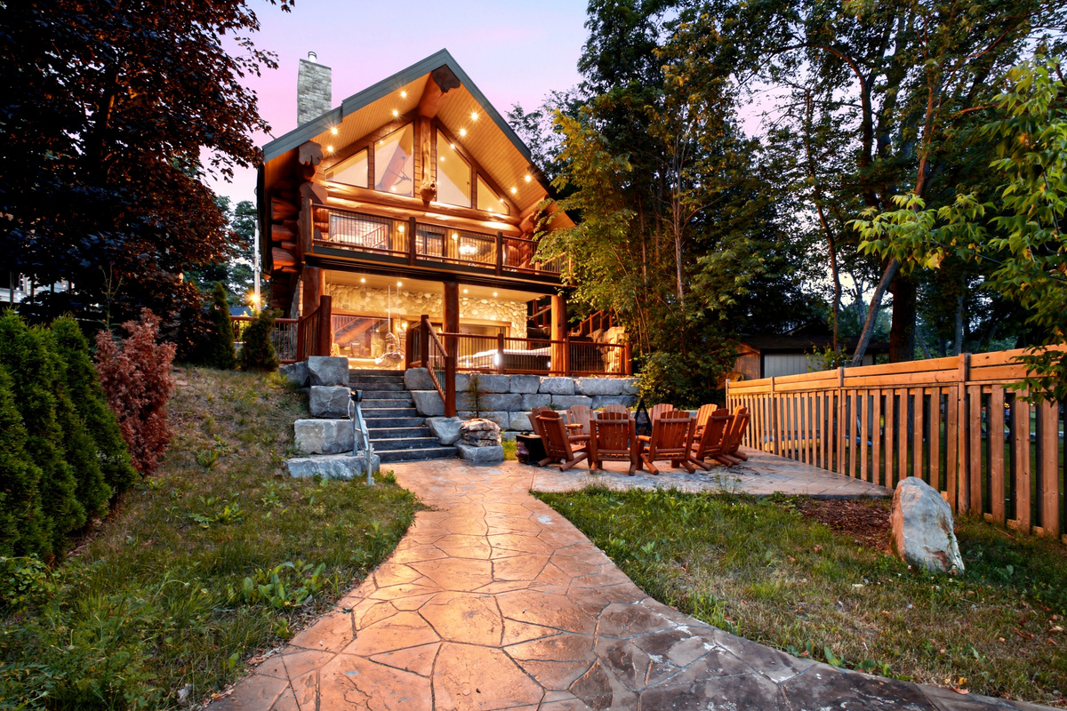 Illuminated Bear Lodge exterior with landscaped pathway at dusk