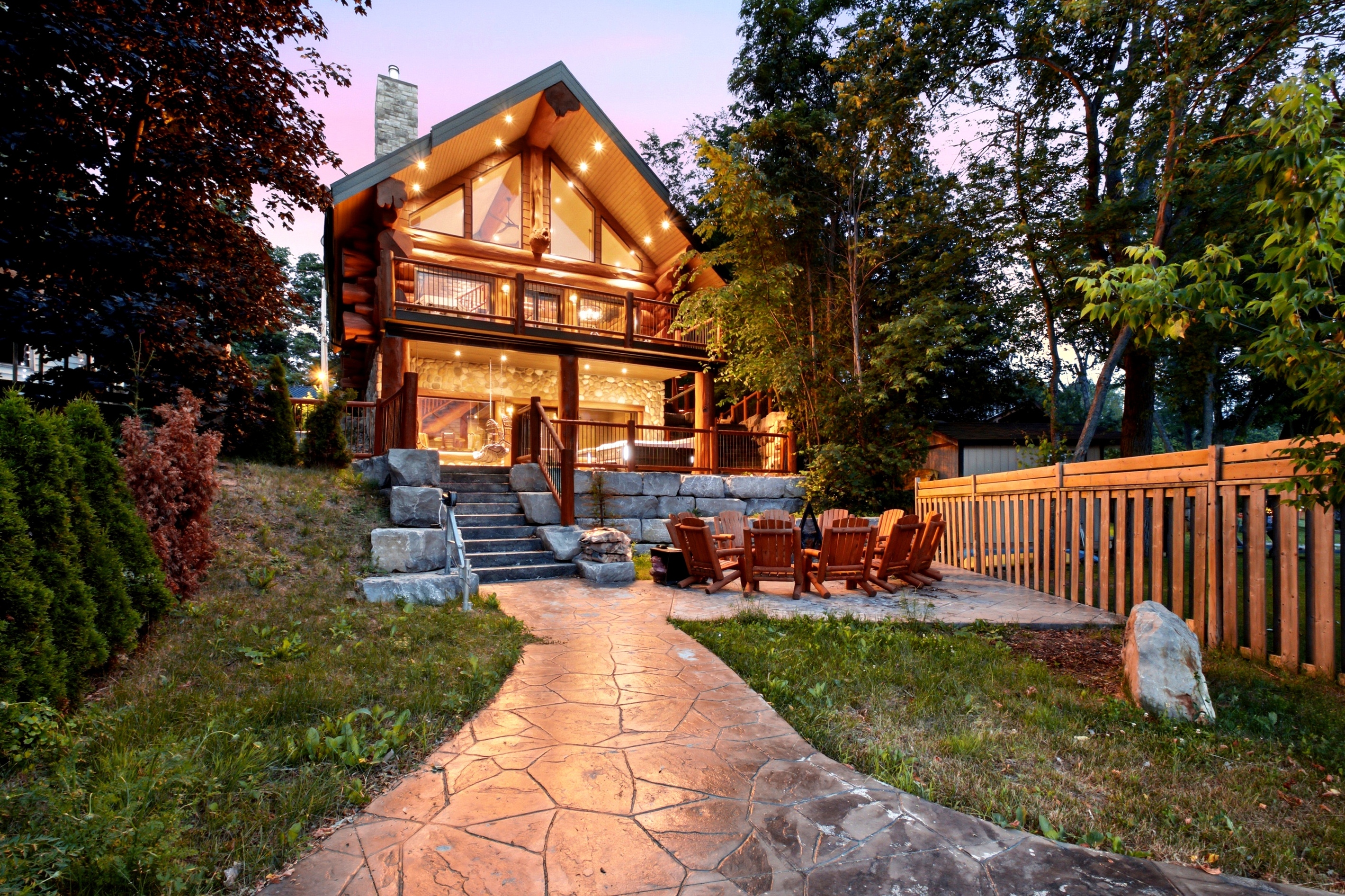 Illuminated Bear Lodge exterior with landscaped pathway at dusk