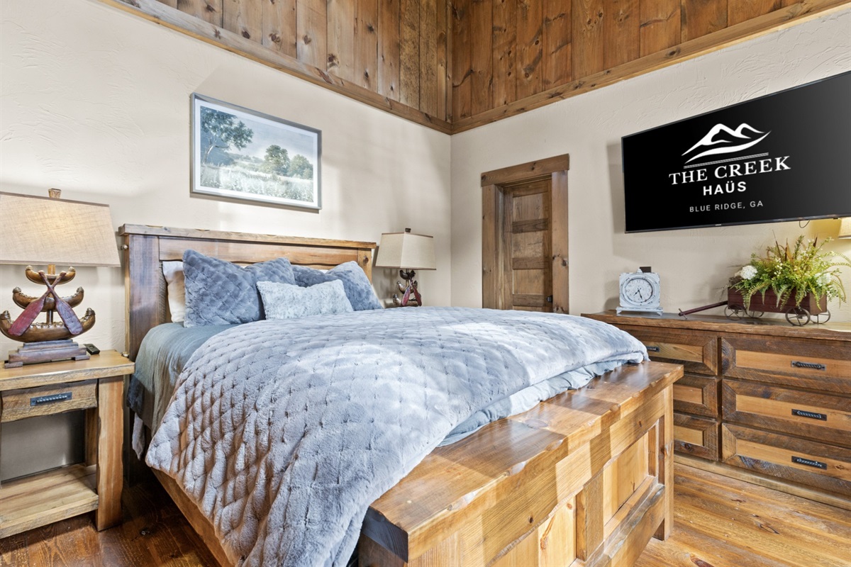 This queen bedroom is a charming retreat, complete with soft linens, thoughtful touches, and a relaxing ambiance.