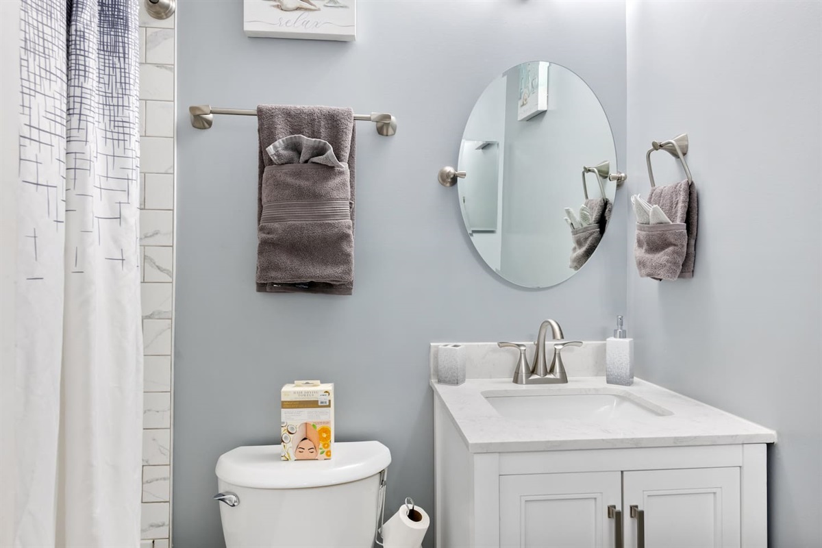A clean, modern walk-in shower with fresh tile and simple design — ideal for refreshing after a day exploring Raleigh.