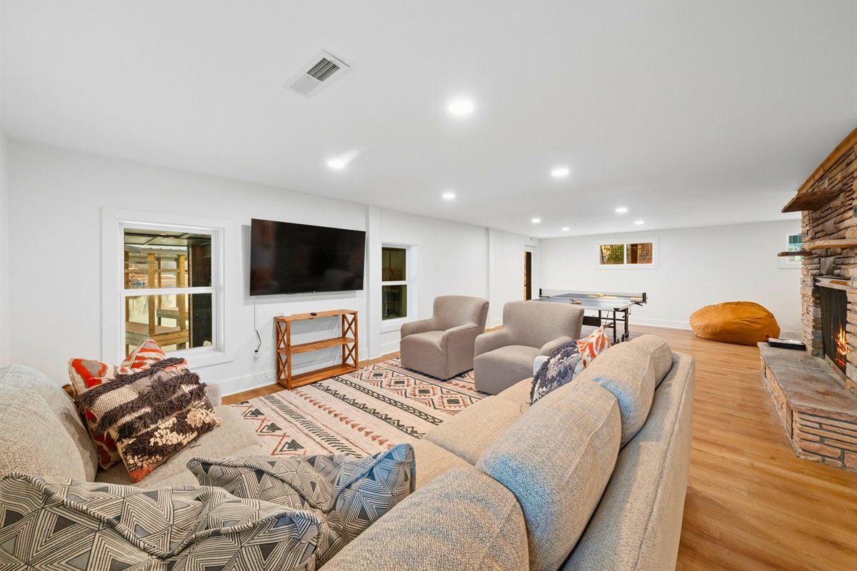 Comfortable couches and a cozy atmosphere make this downstairs gathering space perfect for casual hangouts and movie nights.