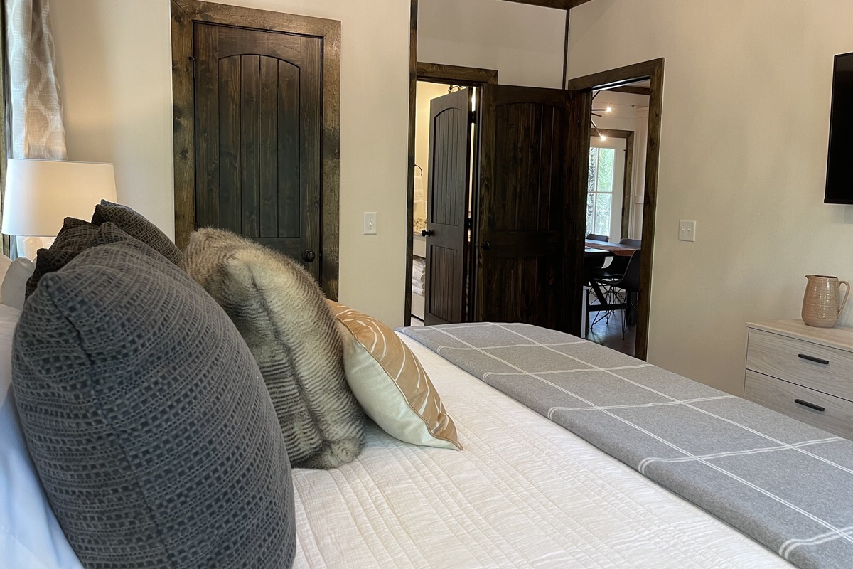 Main bedroom looking towards bathroom and dining area.