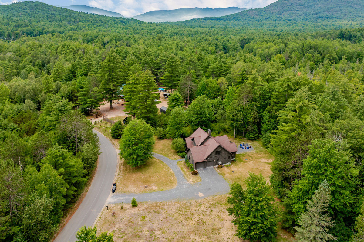Nestled on a spacious wooded lot, this Adirondack getaway offers privacy, natural beauty, and easy access to Whiteface Mountain, hiking, and Lake Placid.