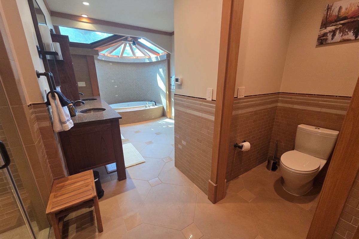 The master bathroom offers a spa-like experience with a deep soaking tub and a large walk-in shower designed for comfort and relaxation.