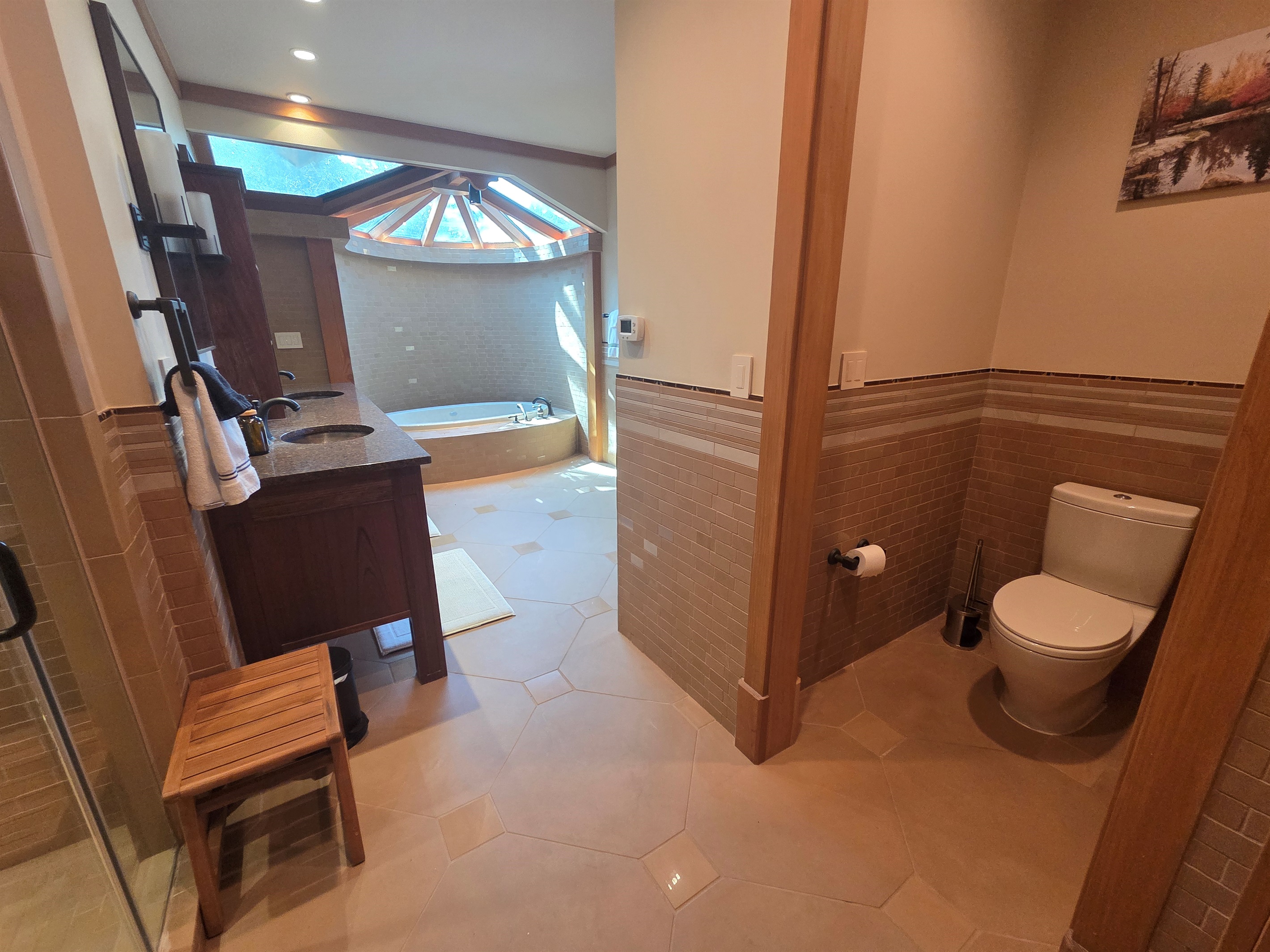 The master bathroom offers a spa-like experience with a deep soaking tub and a large walk-in shower designed for comfort and relaxation.