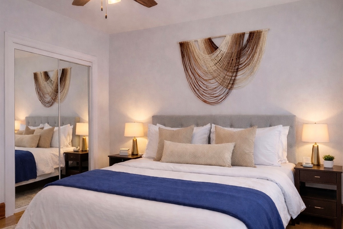 Bright, comfortable bedroom with crisp bedding and peaceful natural light. Perfect for couples, families, or extended stays.