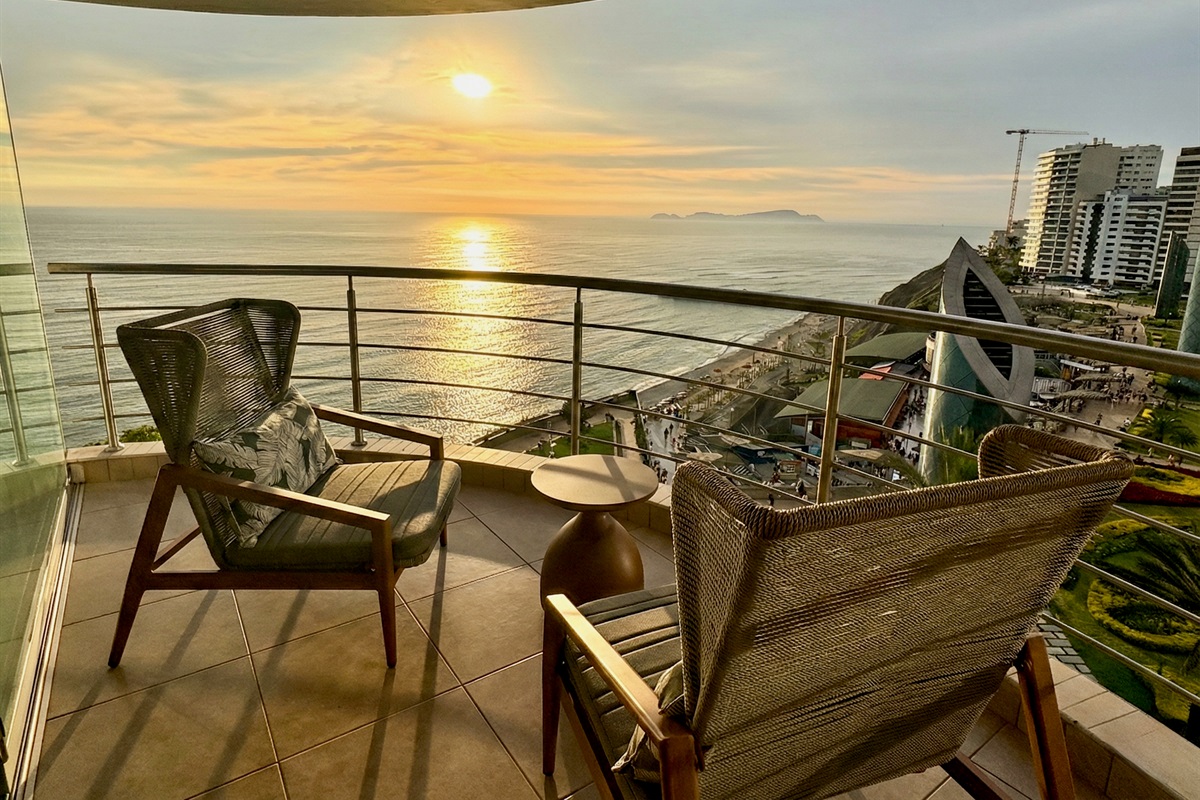 (Photo taken from apartment balcony) View from the living room at evening. World-Class Sunsets: Your private front-row seat to the most magical golden hours in Lima, right from your unique curved balcony