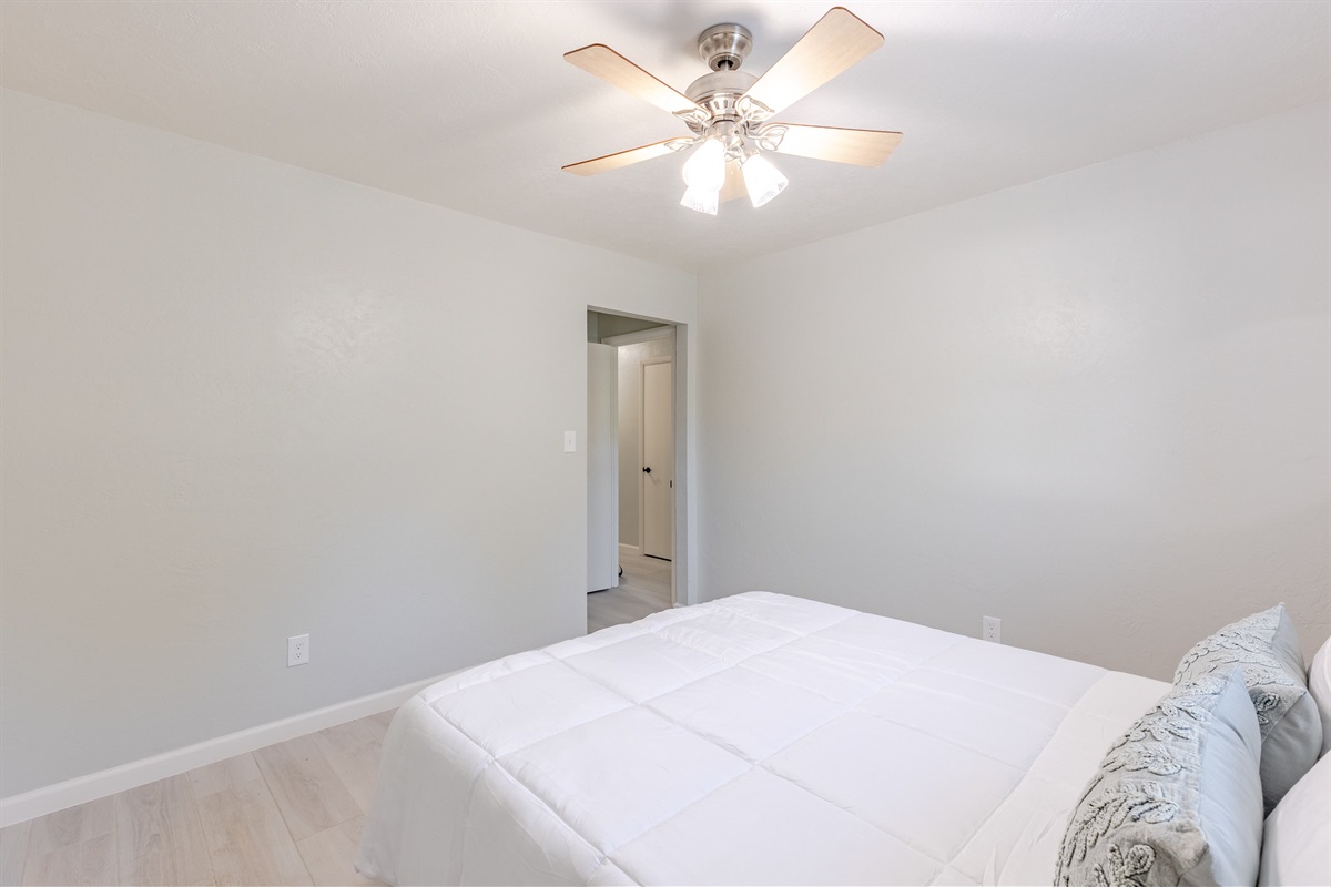 Bright and comfortable guest room with a cozy queen bed.