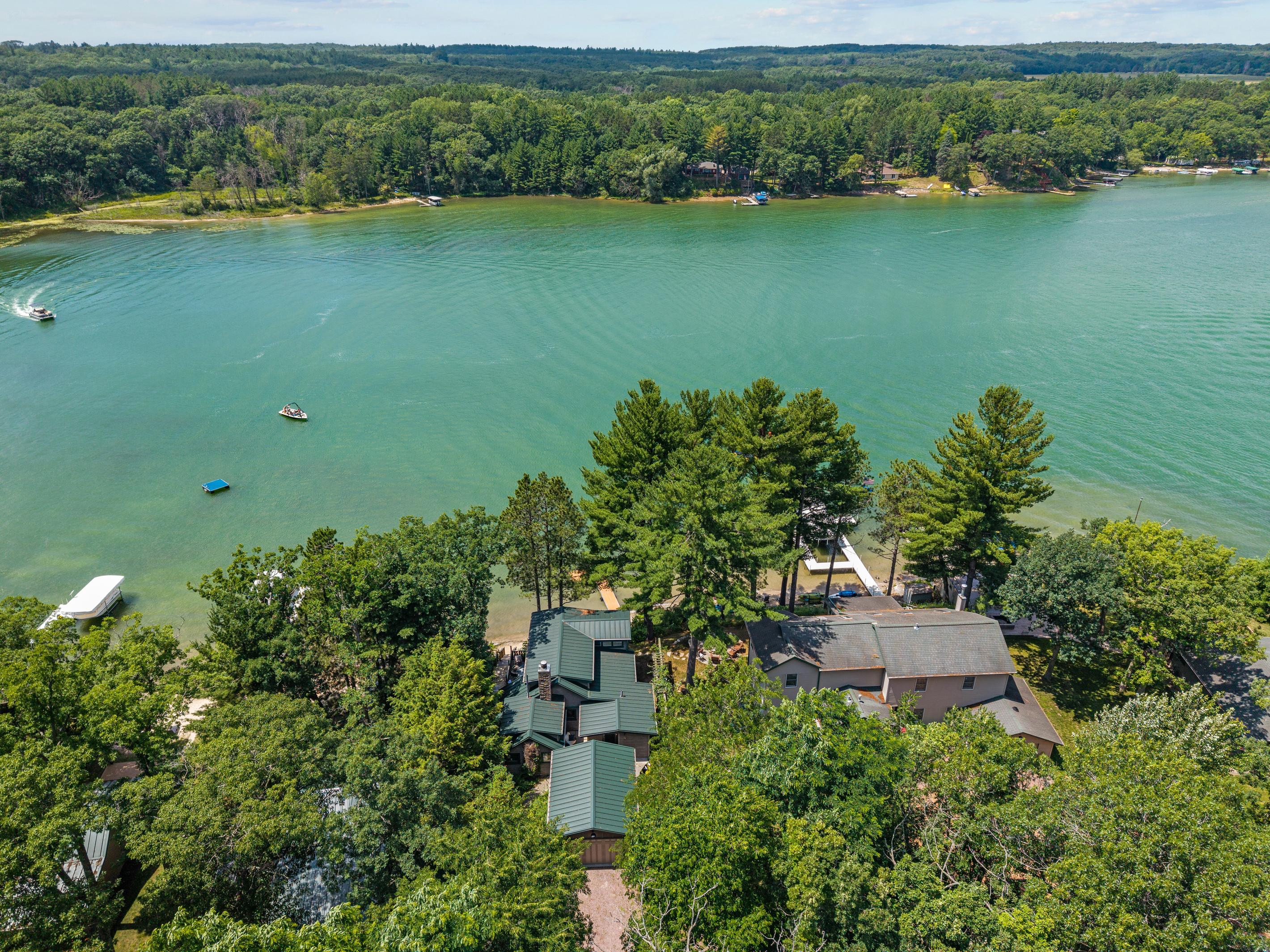From above, you'll see everything that makes this getaway special—your cozy cottage, sandy shoreline, and beautiful waterfront setting.
