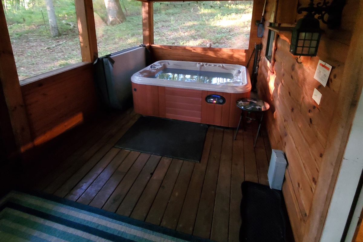 Tucked away on the screened cedar porch, the hot tub provides a serene, private spot for relaxing soaks.