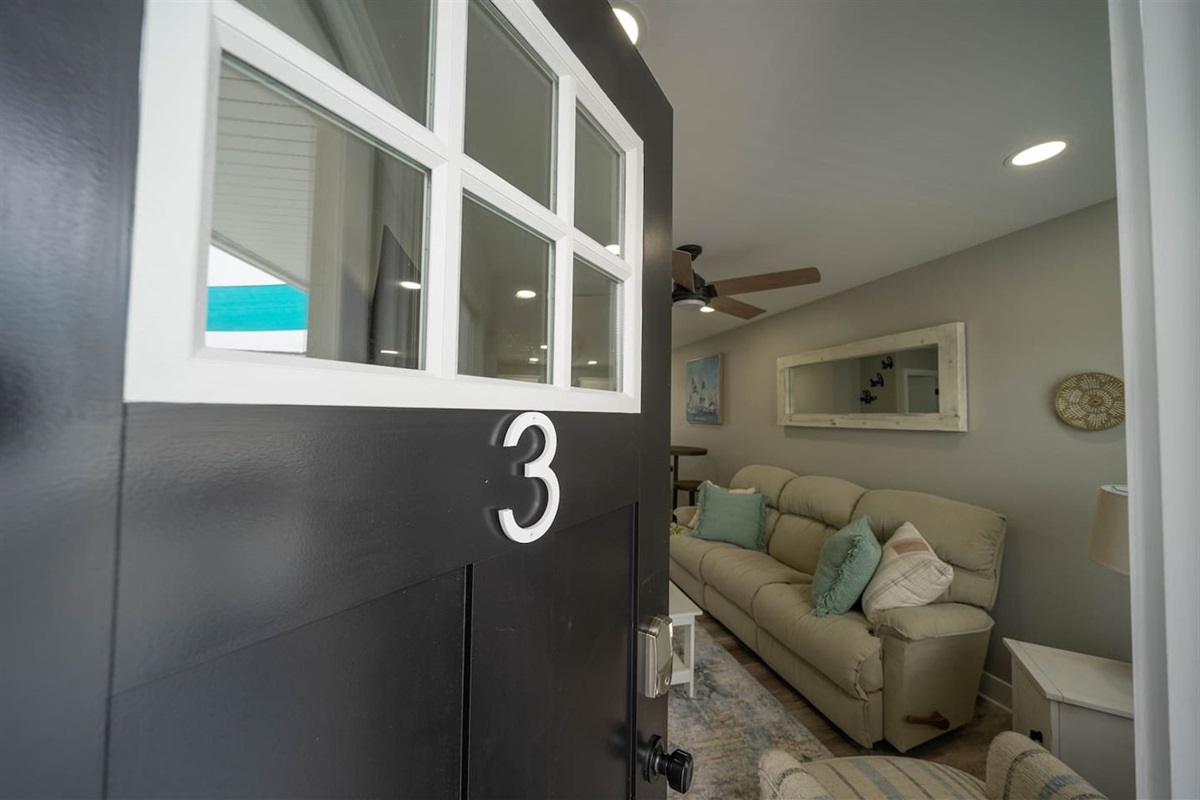 Welcoming private entry opens directly into a bright living space with comfortable seating and soft coastal accents. The easy self check-in and direct access create a smooth arrival and an immediate sense of comfort and relaxation.