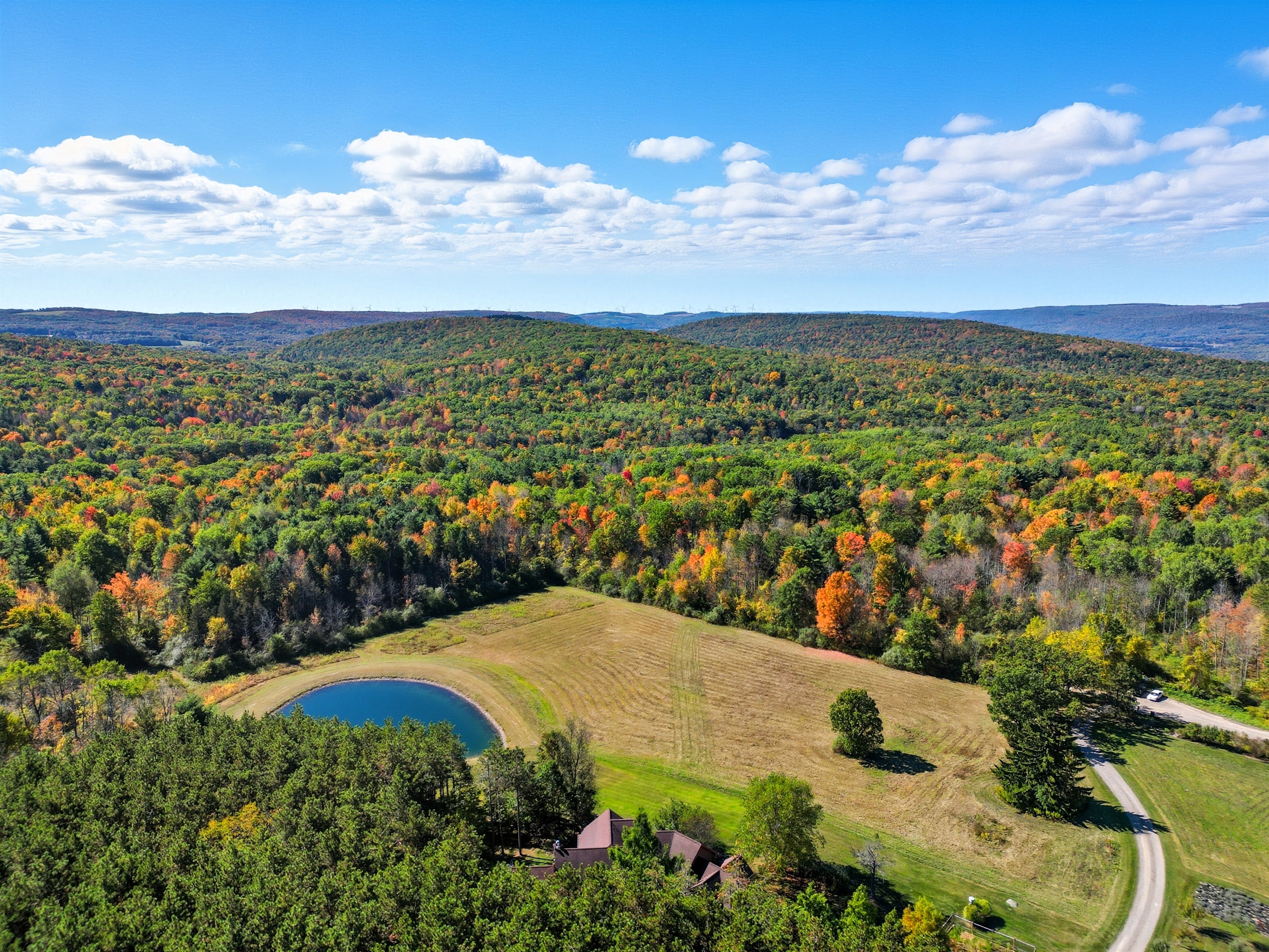 Escape to your own private retreat surrounded by rolling hills and forest. This stunning property features a spring-fed pond with a dock, wide-open meadows, and total privacy—perfect for relax