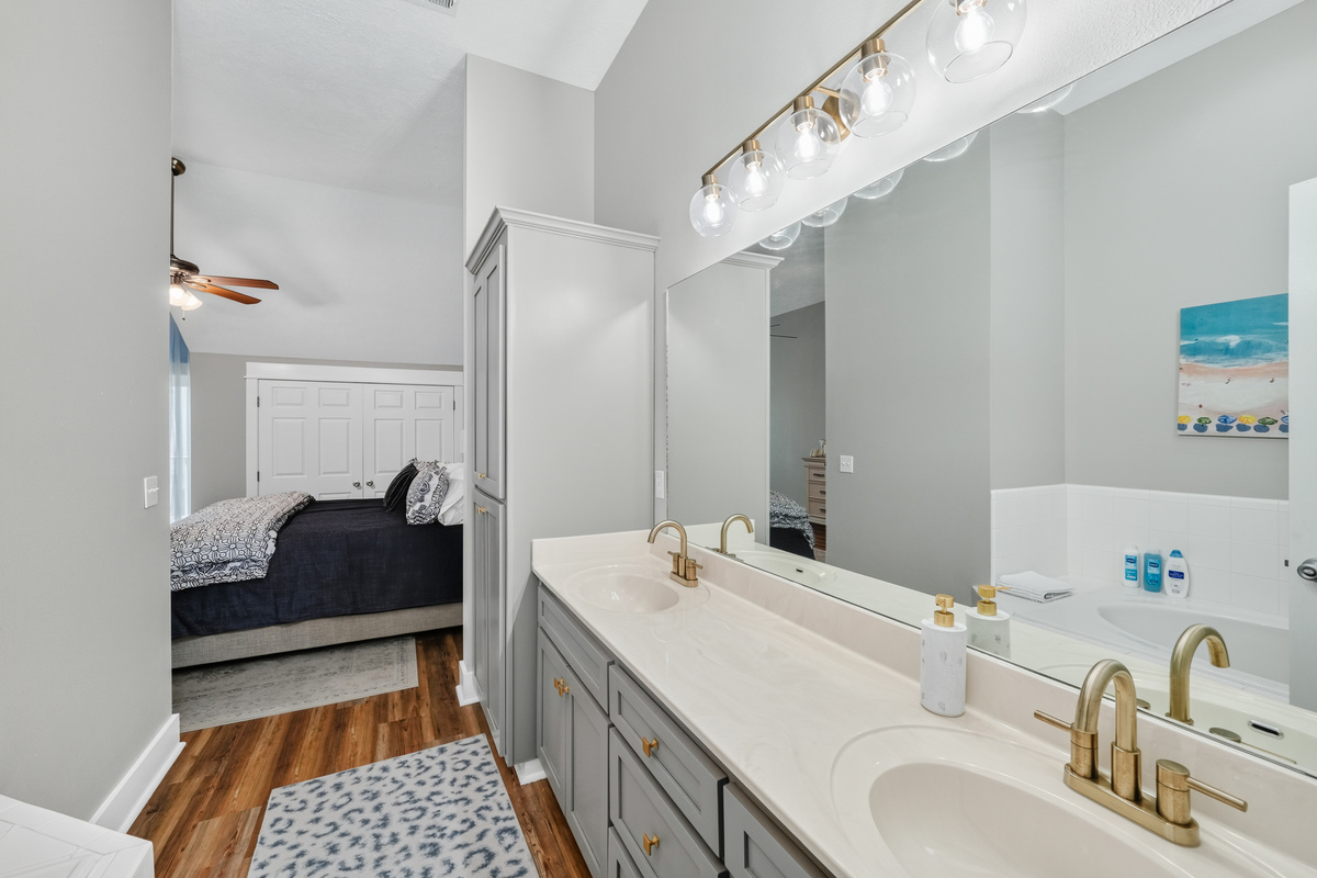 Enjoy the convenience of a private en-suite bathroom with dual vanities, a full-size bathtub, and plenty of space to refresh and unwind after a day of adventure