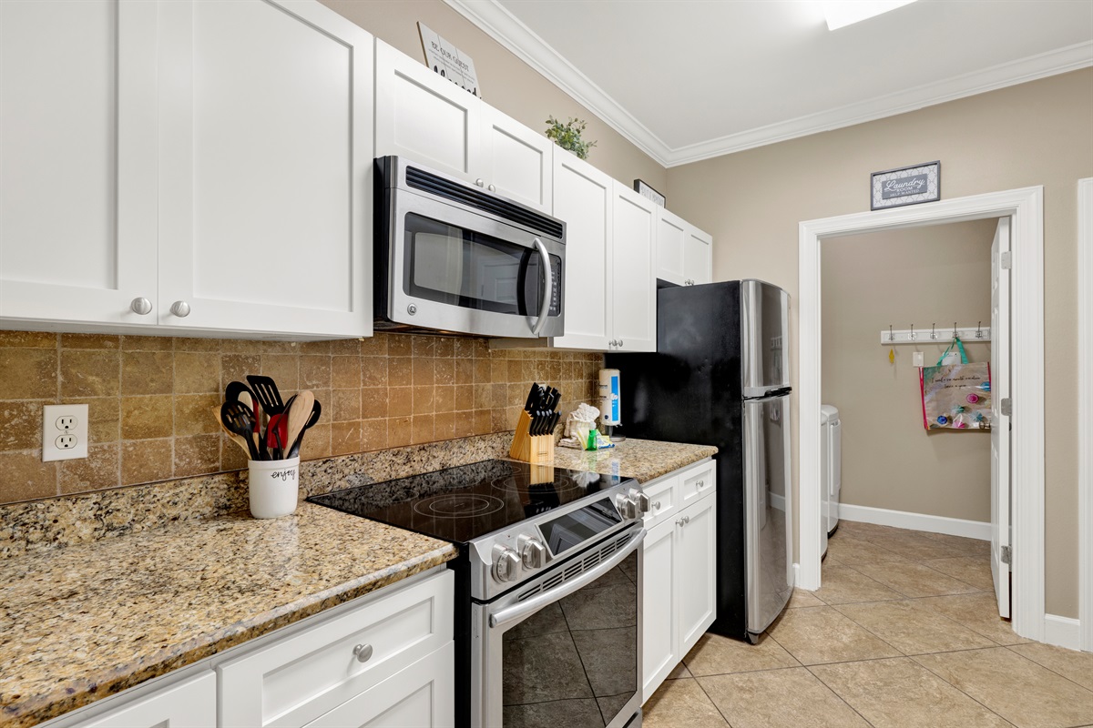 Kitchen with granite tops, stainless appliances and it is fully stocked with everything you need to prepare your meals 