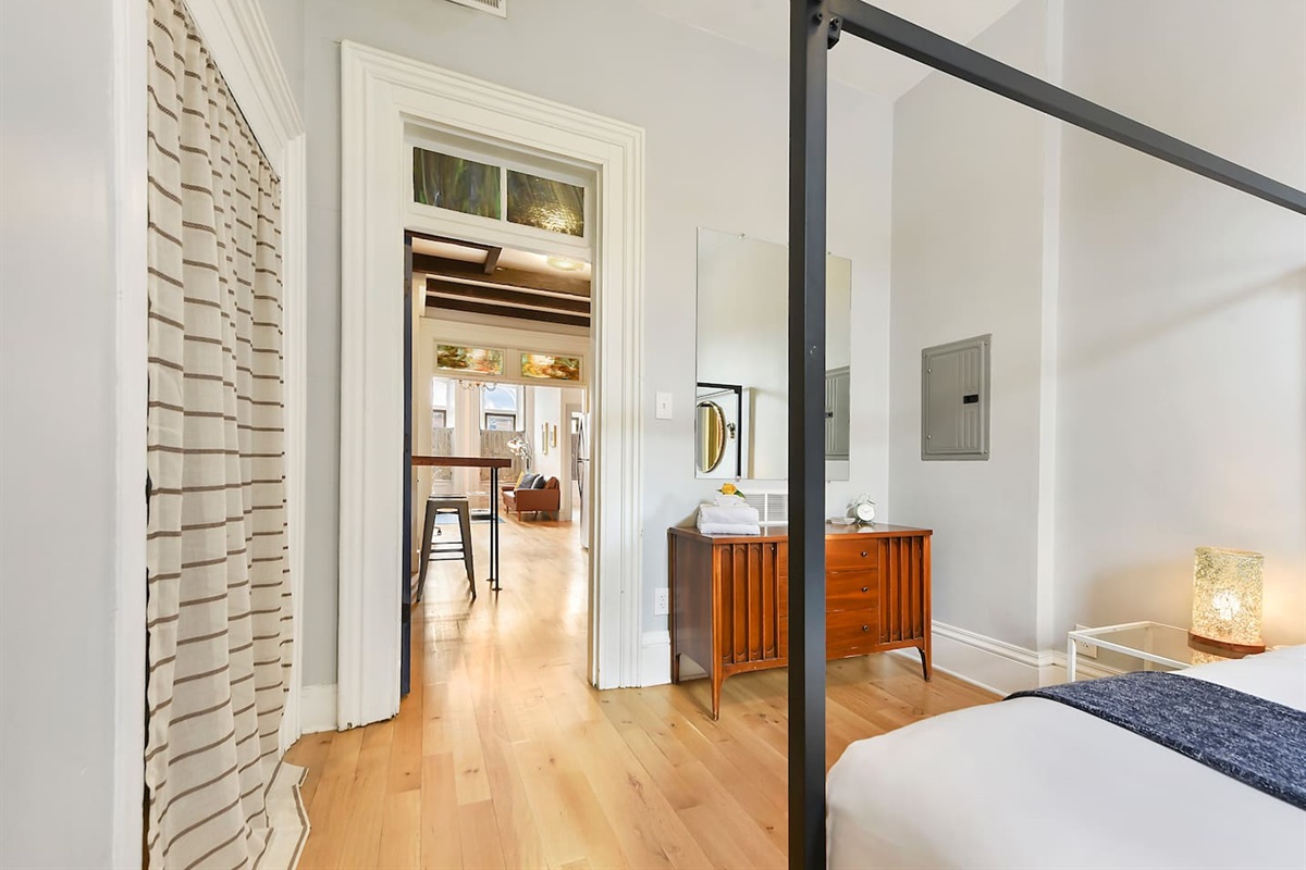 Cozy queen-sized bed with a unique frame and a TV for laid-back movie nights.