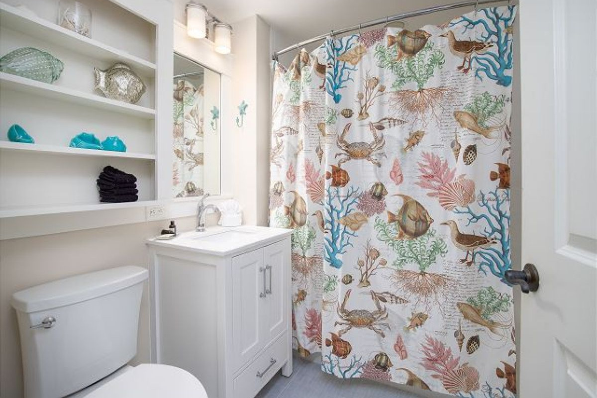 Full bathroom with tub and shower, single vanity and built-in shelving