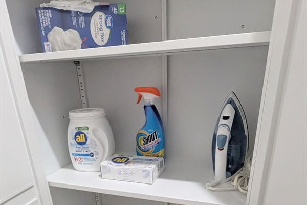 Cabinet next to laundry has all the necessary supplies.