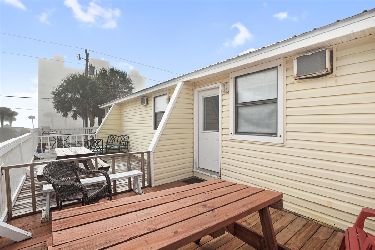 Balcony - The spacious balcony features seating, and a table for enjoying meals outdoors.