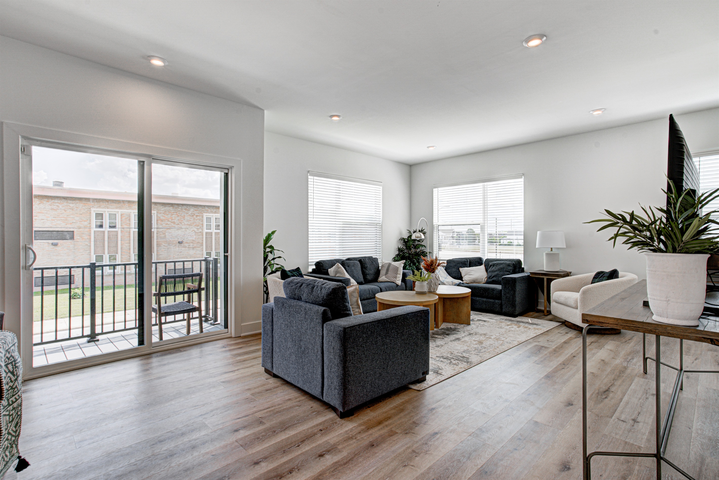 Enjoy a designed open-concept space with a modern kitchen equipped with quartz countertops, stainless steel appliances, and all essentials for home cooking. 