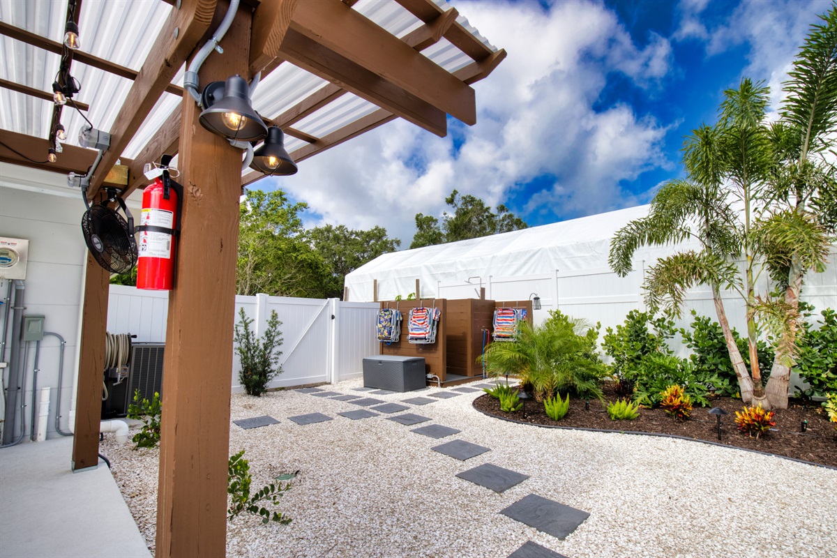 Outdoor shower with hot/cold water.  Beach chairs and toys are located at the shower.