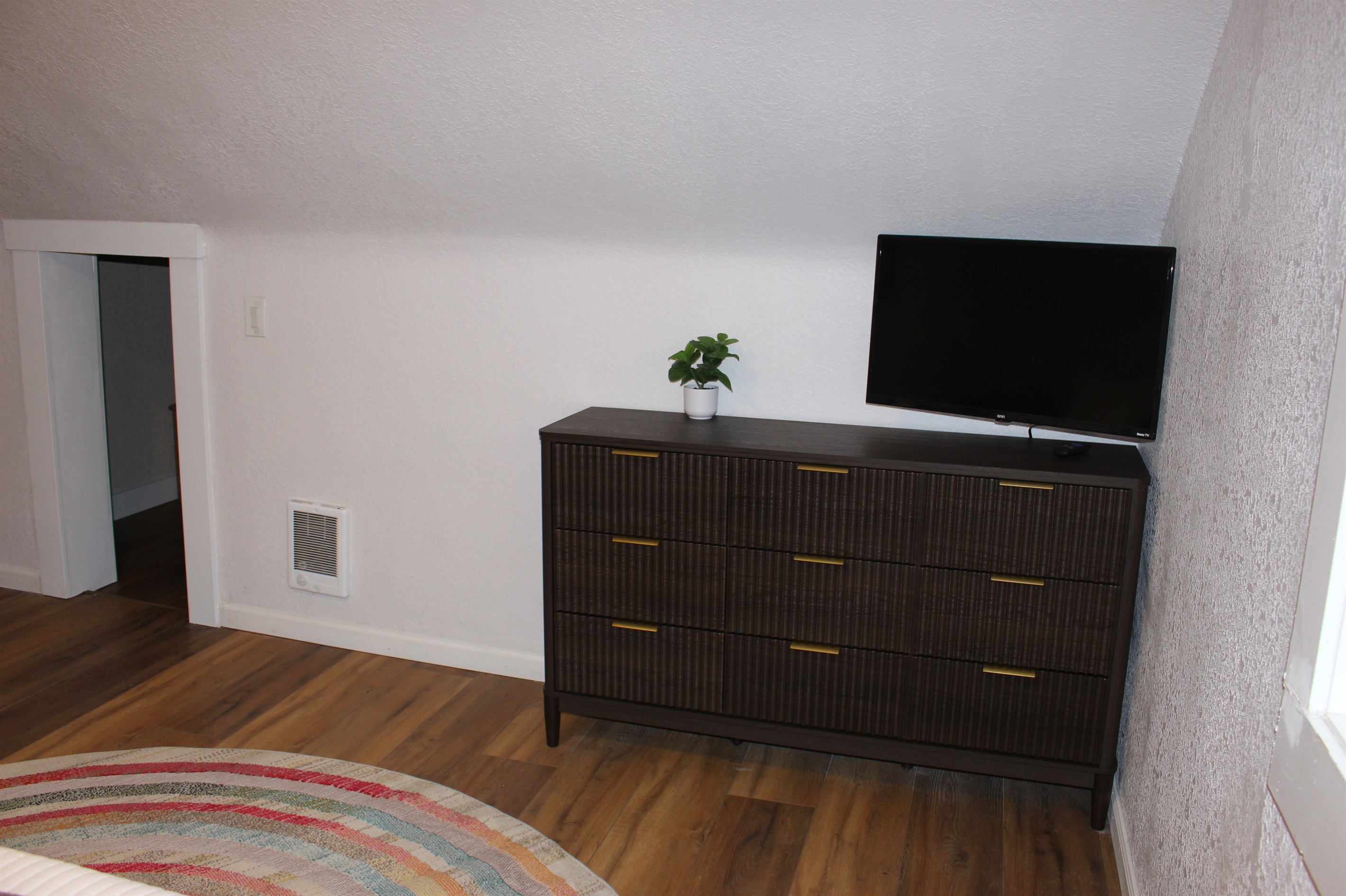 Dresser and Roku TV in every bedroom. View of upstairs Primary king bedroom.
