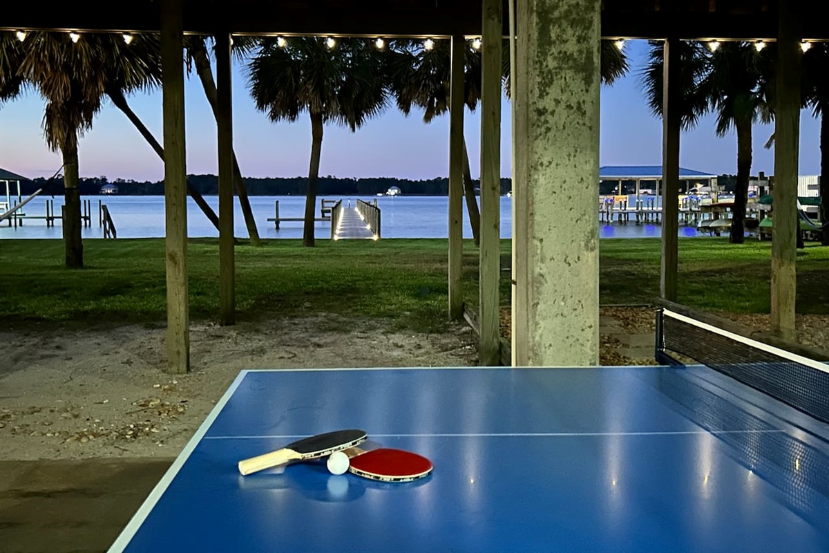Lakeside retreat with ping pong table and serene sunset vibes.