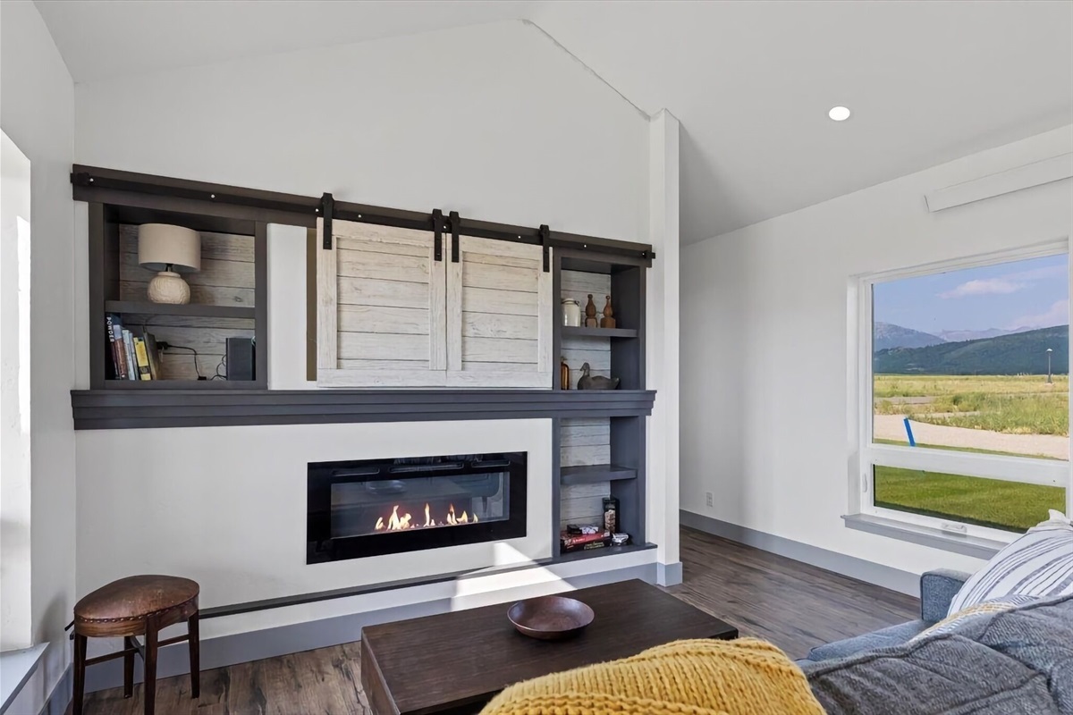 Kick back and relax in the living room, taking advantage of the inviting seating, a smart TV, and a cozy electric fireplace.