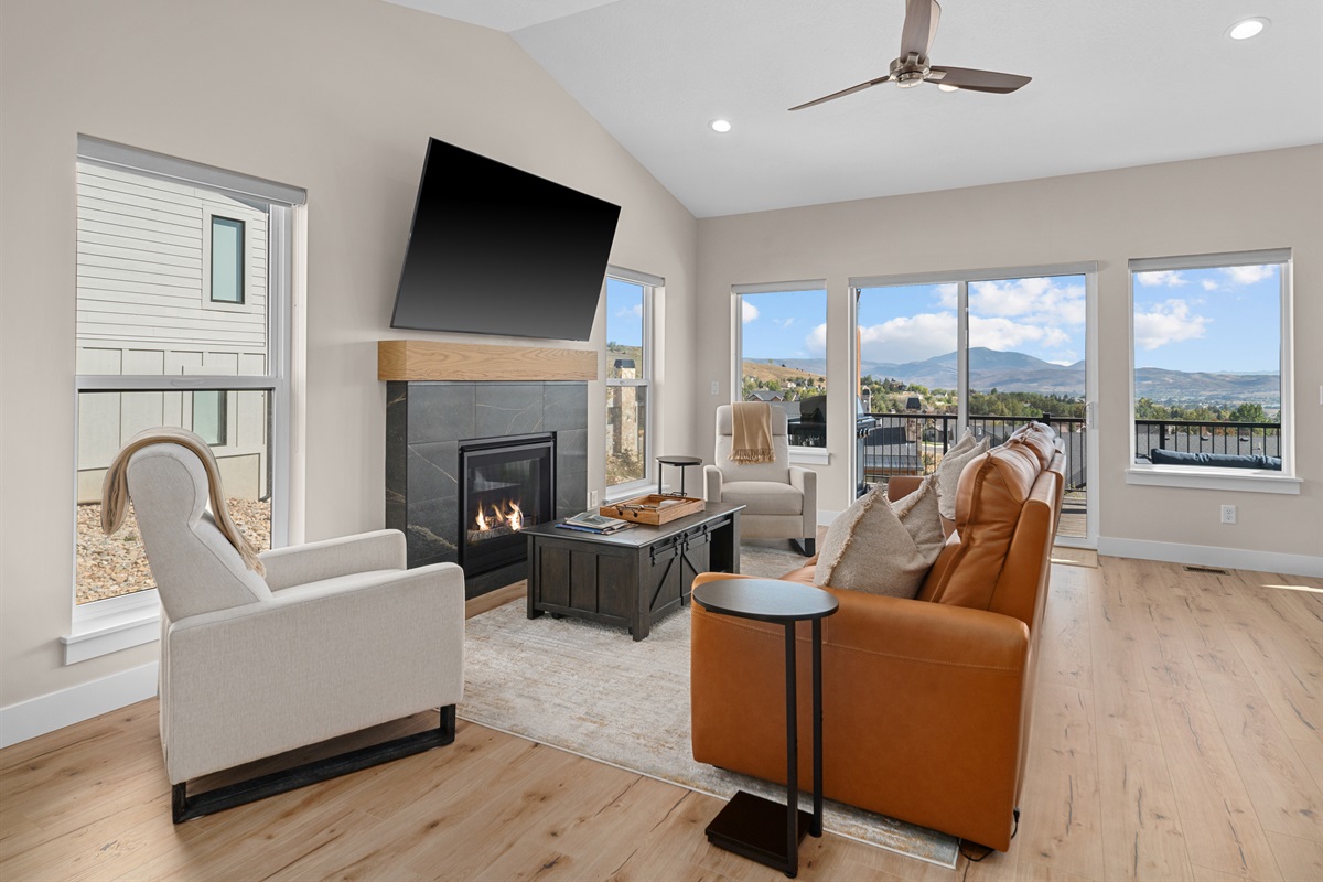 Bright, open living space with mountain views and a cozy fireplace—perfect for gathering and relaxing.