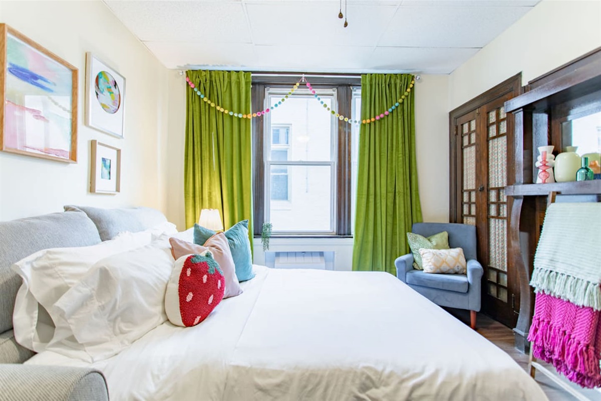 Bright and spacious living room featuring a comfortable sofa bed, perfect for relaxing or accommodating extra guests.