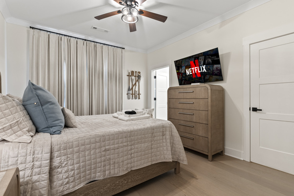 Queen size bed, walk in closet, attached bathroom, view of the front yard.