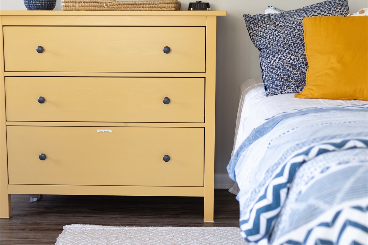 Full size dresser with extra blankets in bottom drawer