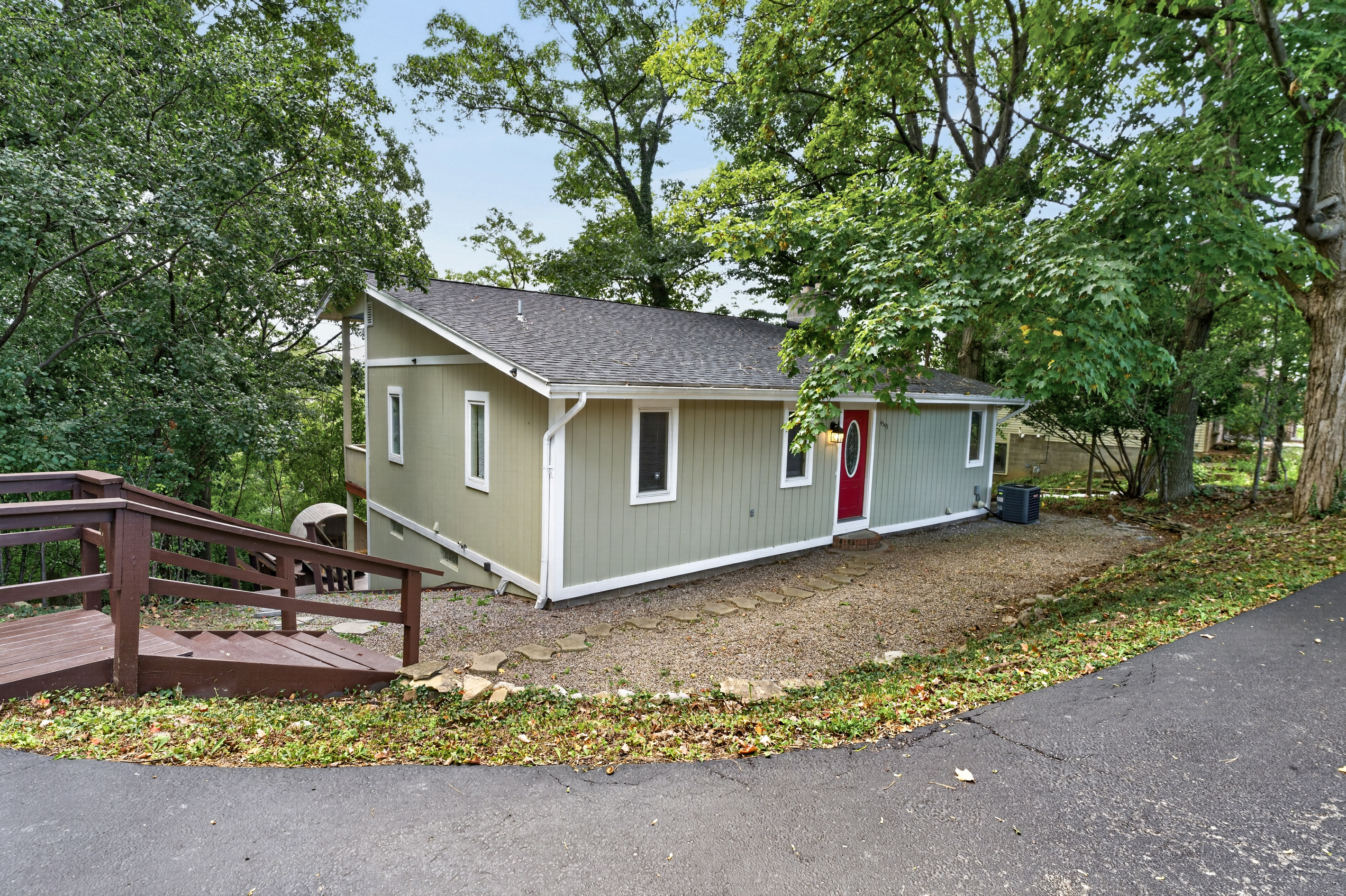 Side exterior with raised wooden deck