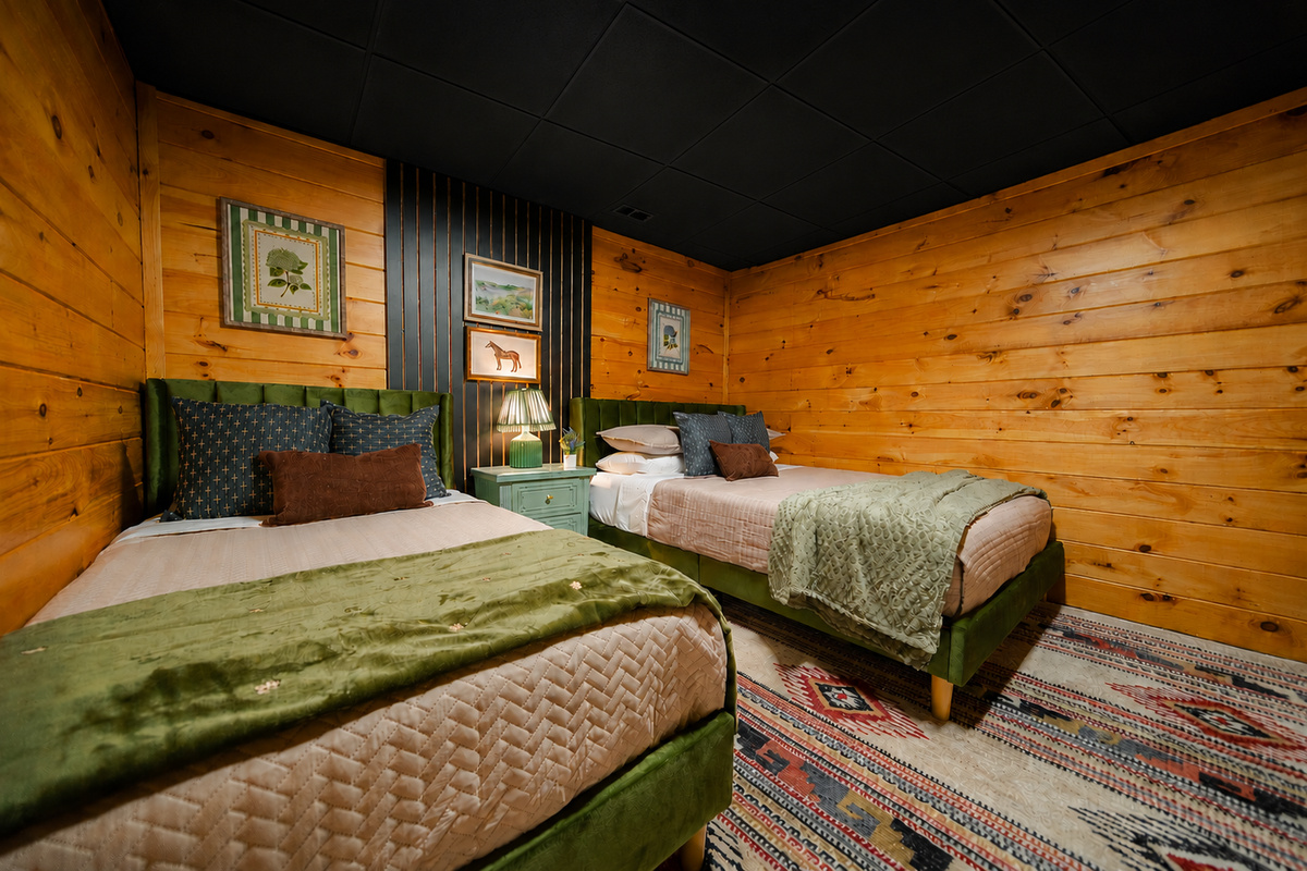 Charming bedroom with a queen bed and twin bed, blending warm rustic character with a cozy, comfortable sleeping space.