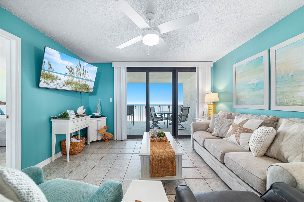 Enjoy your morning coffee with a breathtaking ocean view from the comfort of this living room, featuring a sleeper sofa for extra guests.