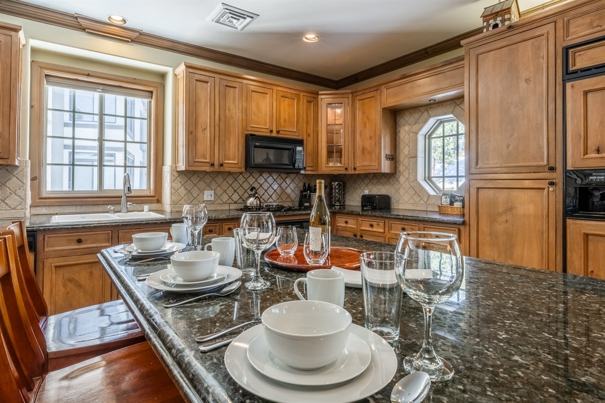 Warm wood finishes and a large kitchen island create the perfect spot for breakfast or après-ski snacks.