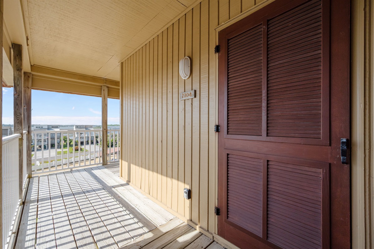 Private entry walkway with storage and breezy coastal charm