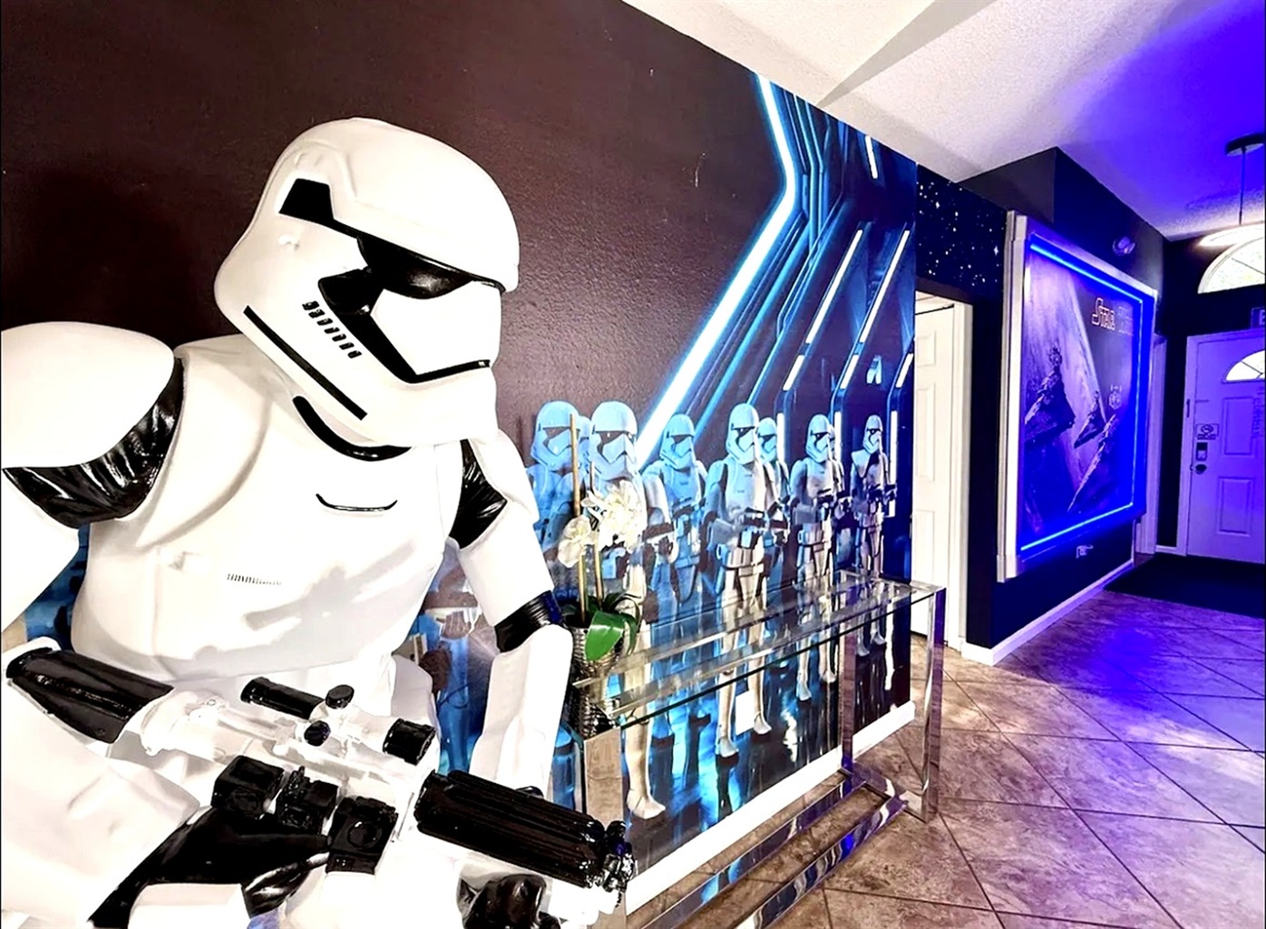 A modern hallway featuring a stormtrooper figure and themed wall art for a unique atmosphere.
