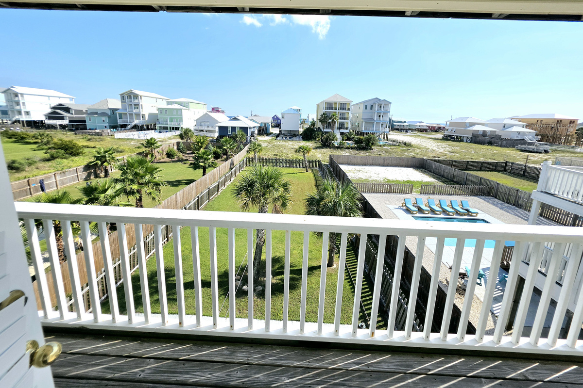 Balcony view overlooking the fenced backyard