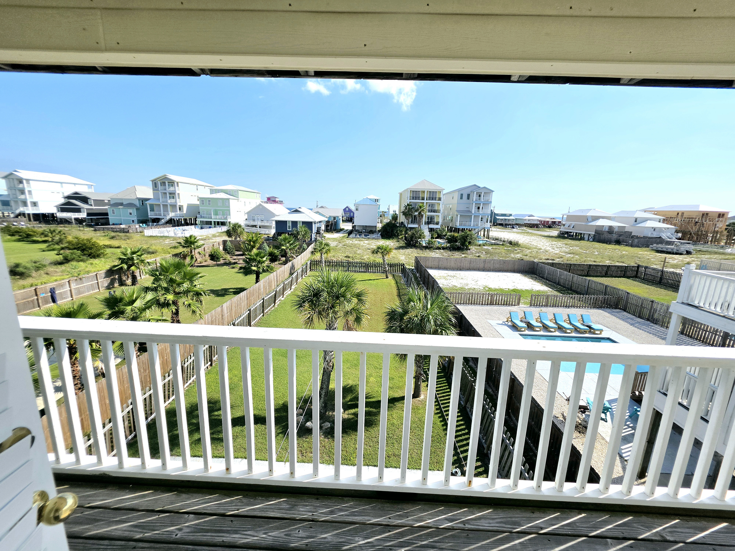 Balcony view overlooking the fenced backyard