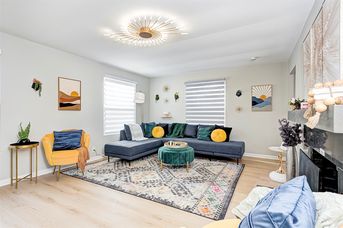 Bright and stylish second living room with a comfy sectional, mid-century accents, and plenty of room for family conversations and downtime between games