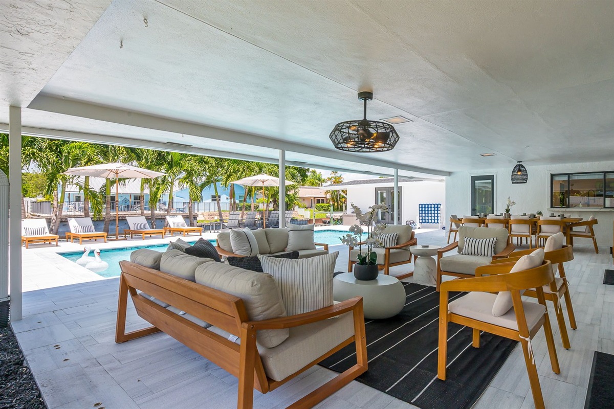 Designed for luxury and comfort, this outdoor space invites you to dine, relax, and unwind in true resort fashion. Enjoy poolside loungers, shaded patio seating, and an ambiance that blends modern elegance with the ease of Florida living