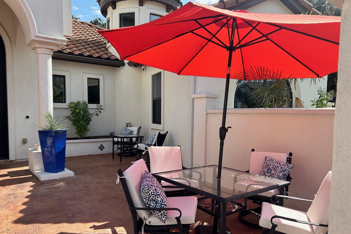 "Welcome to your serene getaway! This beautiful courtyard greets you with lush landscaping, a tranquil fountain, and inviting seating areas—perfect for unwinding and soaking in the peaceful am