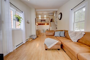 Living room couch with stairs in the background