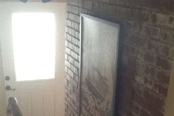 Exposed brick to the sunken living room