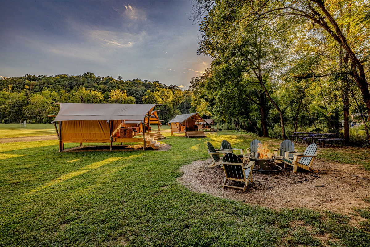 Golden hour at your mountain getaway. Gather around the fire pit with comfortable seating arranged perfectly for evening storytelling in Satrgazer Farm Glamping.