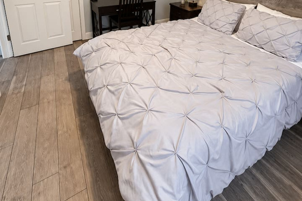 Bedroom Oasis: Bright room with plush bedding and a stylish desk for a refreshing retreat!