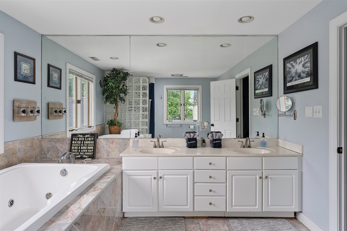 Master Bathroom 1: Indulge in luxury with a soaking tub and serene views—your personal spa awaits!